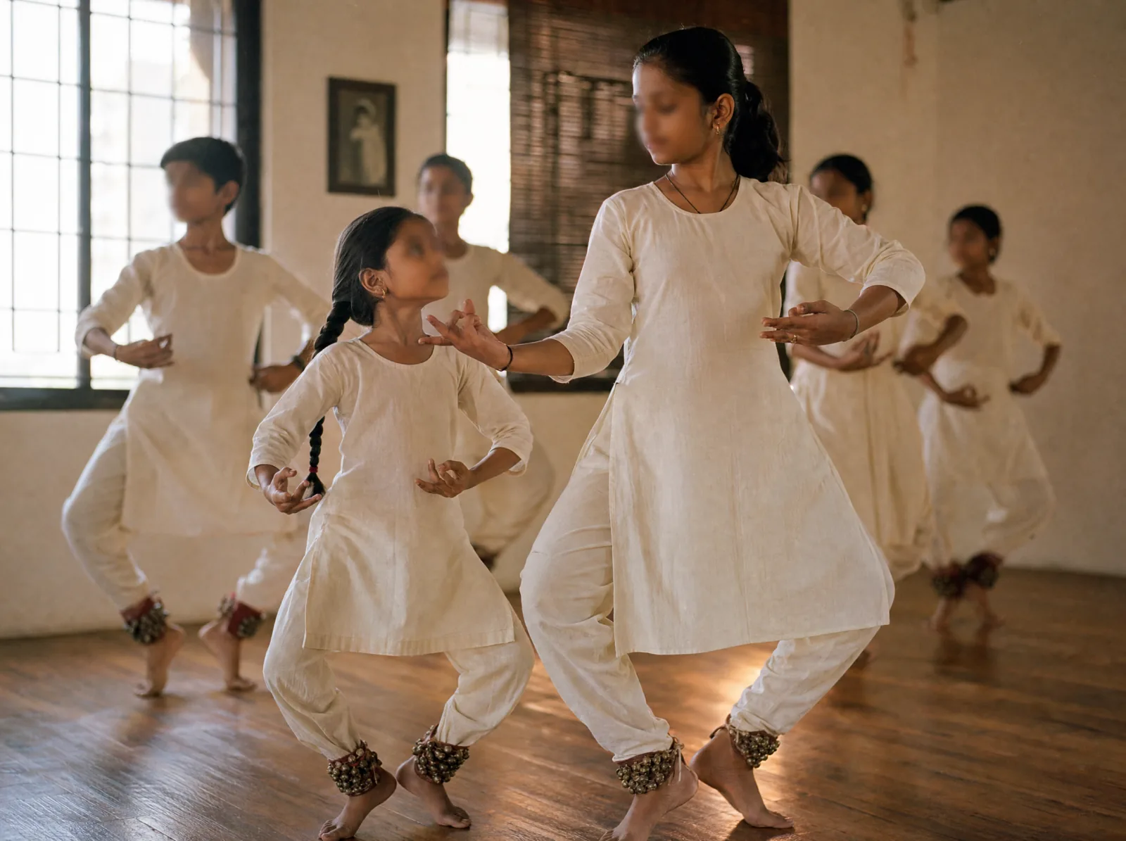 A small group of young dancers in a focused rehearsal